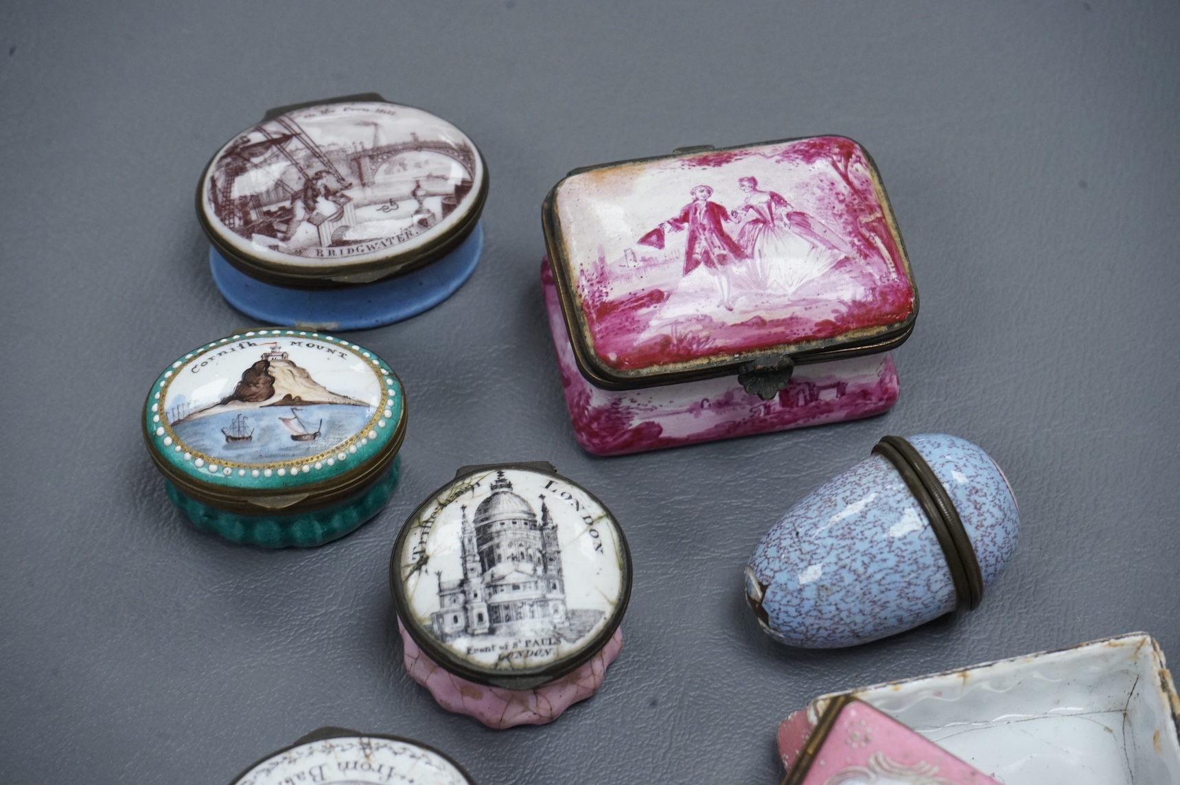 A collection of seven late 18th / early 19th century South Staffordshire enamel patch and snuff boxes and a continental porcelain snuff box, Largest 3.5cm high (8)